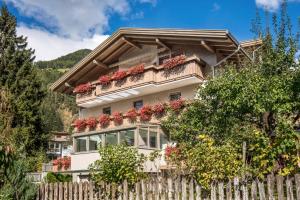 a house with flower boxes on the balcony at Apartments Silva Alpenblick in San Giovanni in Val Aurina