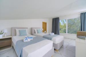 Posteľ alebo postele v izbe v ubytovaní Hotel ASTERA