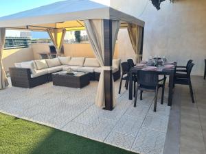 a living room with a couch and a table with chairs at Stunning Villa with Pool in Albufeira