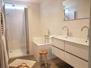 a white bathroom with a sink and a shower at De Egel in Oostkapelle +37 photos