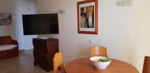 a living room with a table with a bowl of fruit on it at Praia Oura Sunset in Albufeira