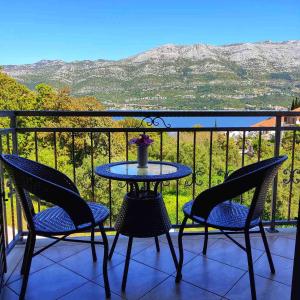 a table and chairs on a balcony with a view at Apartment Yadi in Korčula