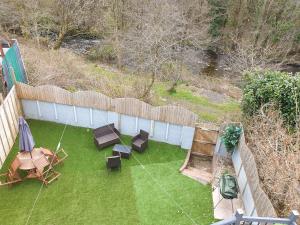 an aerial view of a backyard with chairs and tables at Riverside cottage in Treherbert