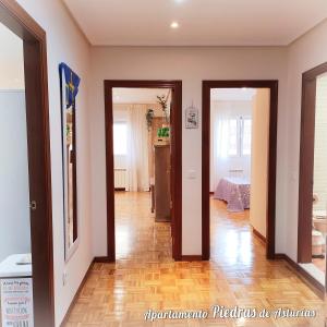 a hallway with two open doors to a room at PIEDRAS DE ASTURIAS in Piedras Blancas