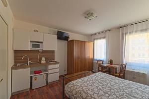 a bedroom with a bed and a kitchen with a sink at B&B Sognare A Venezia in Venice