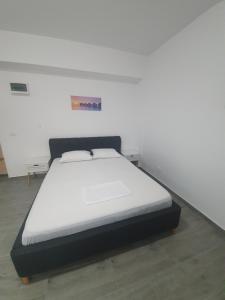a bed in a room with a white mattress at Brizza Apartments 3 Mamaia Nord in Năvodari