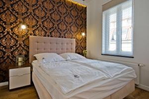 Un dormitorio con una gran cama blanca y una ventana en Imperial Apartments - Haffner Lux en Sopot