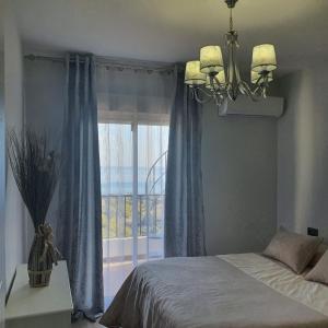 En eller flere senge i et værelse på Niza Beach