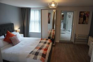 a hotel room with a bed and a mirror at VIP Church View Apartment in Portadown