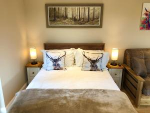 a bedroom with a bed with two antelope heads on it at Stronaba Croft Cabins in Spean Bridge