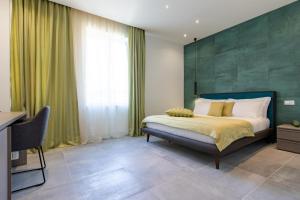 a bedroom with a bed with a green wall at Missori Suites in Milan