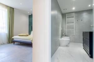 a bathroom with a bed and a toilet and a sink at Missori Suites in Milan