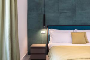 a bedroom with a bed and a green wall at Missori Suites in Milan