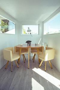 a dining room with a wooden table and chairs at Peniche C'est La Vie in Les Grésillons