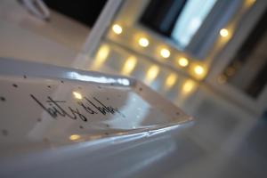 a piece of paper with writing on it next to a door at VIP Church Street Apartment in Portadown +22 photos