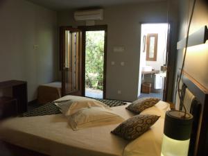 a bedroom with two beds in a room with a window at Hotel Los Patios - Parque Natural in Rodalquilar