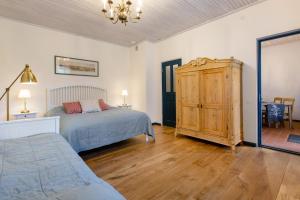 a bedroom with a bed and a dresser in it at Karlamuiza Country Hotel in Kārļi