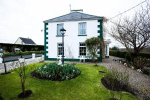 a white and green house with a garden at Bruckless Rest - Fine Country Living in Milltown