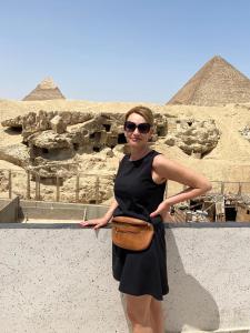 a woman standing in front of the pyramids at Toman Pyramids hotel in Cairo