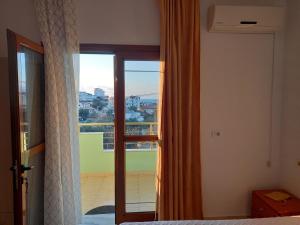 a bedroom with a bed and a window with a view at Jonny Guesthouse in Ksamil +97 photos