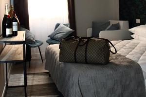 a bag sitting on top of a bed in a room at Vite 99 spanish steps room in Rome