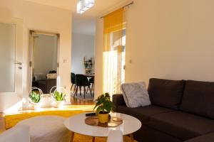 a living room with a couch and a table at Exclusive apartment Visoko in Visoko