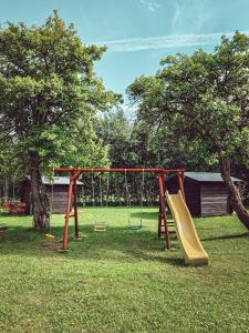 a playground with a slide in a park at Pruuli Puhkeküla in Nurme