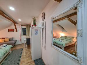 a room with a mirror and a bedroom with a bed at Rooms Garden in Slunj
