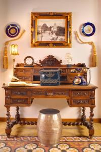 a wooden table with a phone on it in a room at ARCHONTARIKI Historic Boutique Hotel in Ioannina