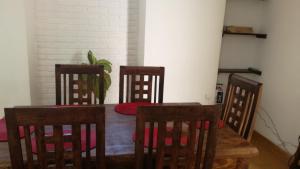 a dining room with a table and four chairs at Casa Gaby in Morelia