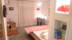 a bedroom with a bed and a desk with a table at Maison de L'ocean Praia 250 m in Florianópolis