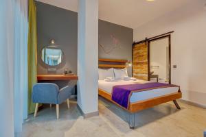 a bedroom with a bed and a desk and a mirror at Villa Kore Cesme in Çeşme