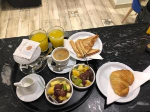 a black table topped with plates of food and drinks at Hostal Paris in Barcelona