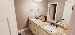 a bathroom with two sinks and a large mirror at Spacious deluxe house for you, your family and friends in Charlotte