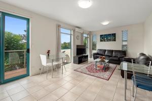 a living room with a couch and a table at Parkhill Accommodation in Whangarei