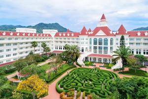 a large building with a garden in front of it at Hong Kong Disneyland Hotel in Hong Kong