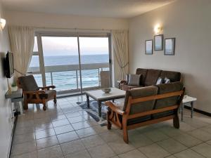 a living room with a view of the ocean at Stella Maris 123 in Amanzimtoti