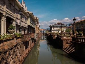 a view of a canal in a city with buildings at Las Casas Filipinas de Acuzar in Bagac