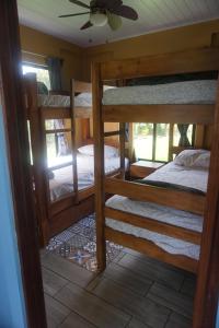a room with three bunk beds in a house at Casitas Joys & Leo - Tucan in Santa Rita