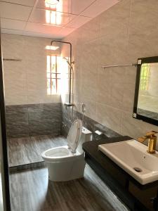a bathroom with a toilet and a sink at Khách Sạn Cương Thảo in Ha Giang +4 photos