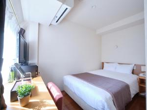Vuode tai vuoteita majoituspaikassa Pod Select Hotel Shinjuku