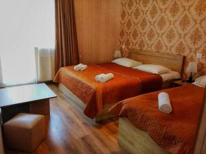 A bed or beds in a room at Kazbegi Inn