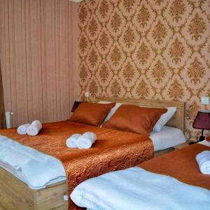 A bed or beds in a room at Kazbegi Inn