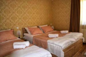 A bed or beds in a room at Kazbegi Inn