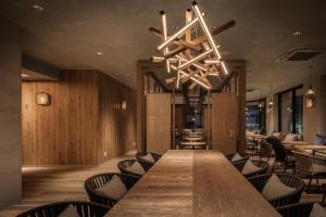 a dining room with a long table and chairs at Nest Hotel Naha Kumoji in Naha