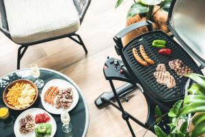a grill with meat and vegetables and other foods at Nest Hotel Naha Kumoji in Naha