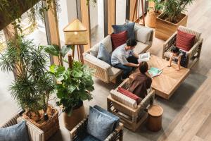 a group of people sitting at a table in a room at Nest Hotel Naha Kumoji in Naha +82 photos
