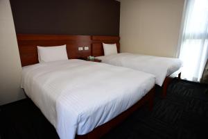 Postel nebo postele na pokoji v ubytování BRILLIANCE Hotel