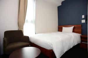 Postel nebo postele na pokoji v ubytování BRILLIANCE Hotel