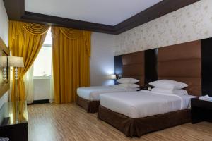 Postel nebo postele na pokoji v ubytování Mangrove Hotel